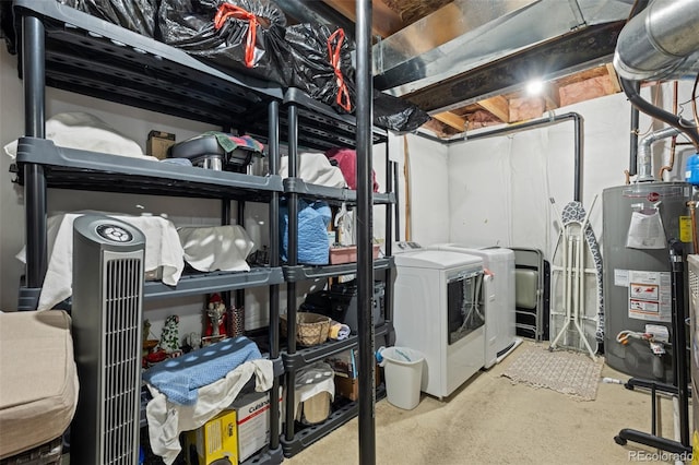 clothes washing area with washing machine and clothes dryer and gas water heater