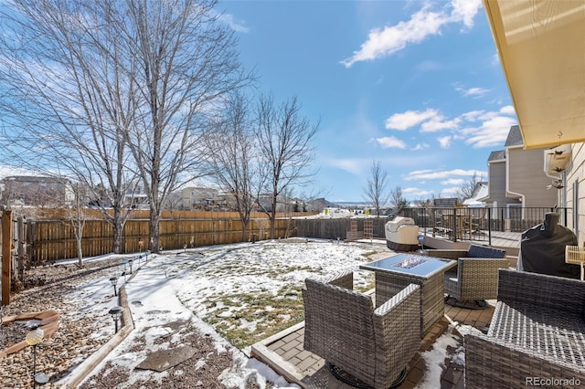 yard covered in snow featuring a fire pit