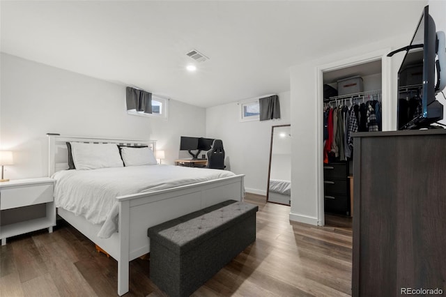 bedroom featuring hardwood / wood-style floors, a spacious closet, and a closet