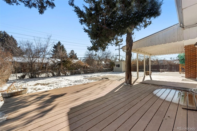 snow covered deck with an outbuilding