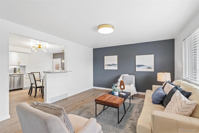 1772 S Pierce St, Lakewood, CO 80232 - living area featuring baseboards, visible vents, and light wood-style flooring