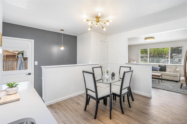 1772 S Pierce St, Lakewood, CO 80232 - dining room featuring wood finished floors and a chandelier