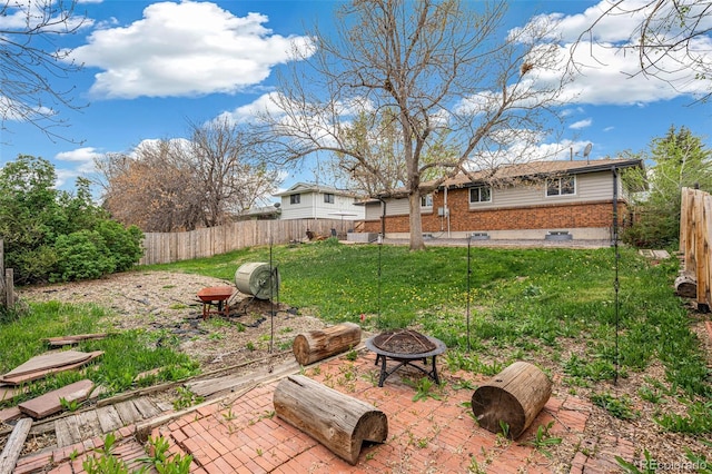 1772 S Pierce St, Lakewood, CO 80232 - view of yard with a patio, a fire pit, and a fenced backyard