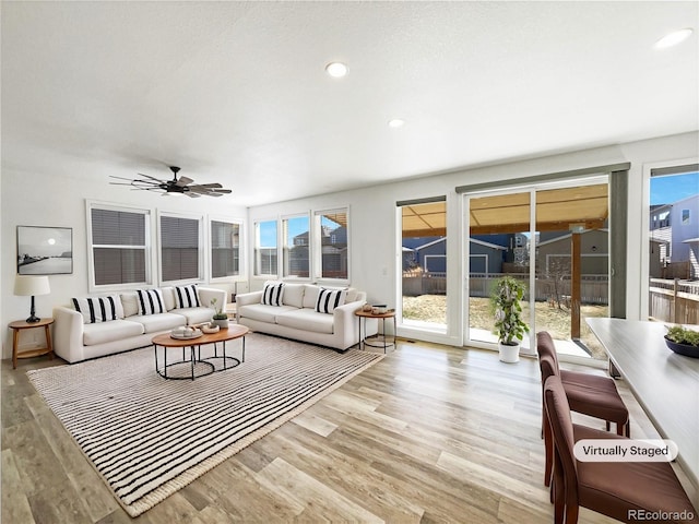 living room with a ceiling fan, wood finished floors, and recessed lighting