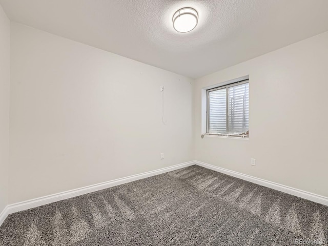 6447 St Vrain Ranch Blvd, Longmont, CO 80504 - spare room featuring dark carpet, a textured ceiling, and baseboards
