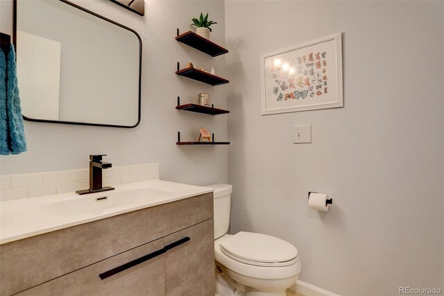 bathroom featuring toilet and vanity