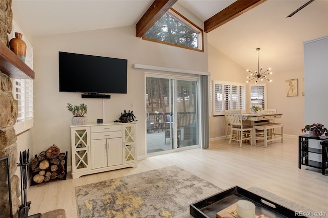 living room with a notable chandelier, a fireplace, wood finished floors, beamed ceiling, and baseboards