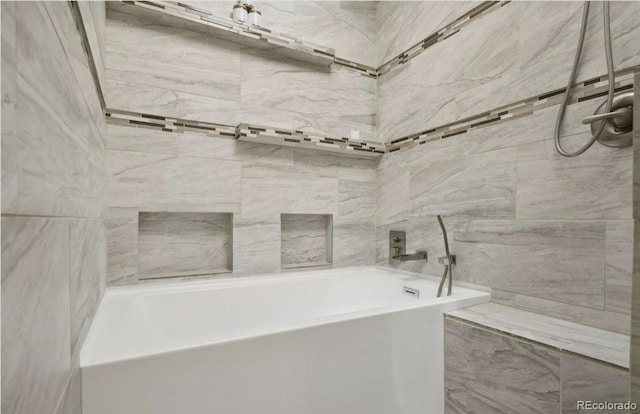 full bathroom with a washtub and a tile shower