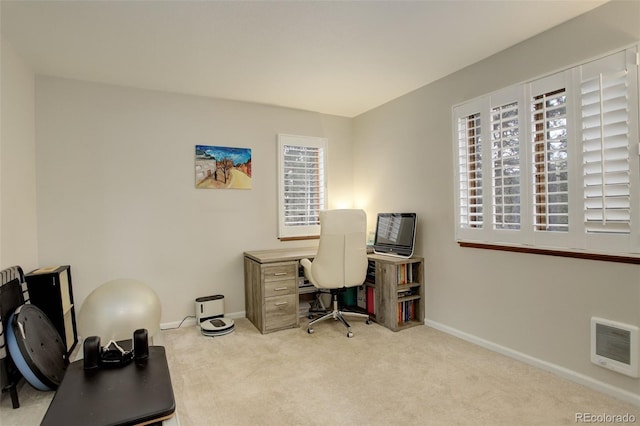 office with heating unit, baseboards, and carpet flooring