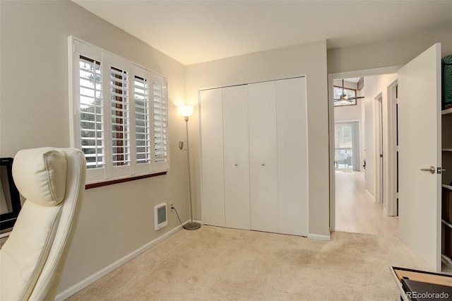 bedroom with baseboards, carpet, visible vents, and a closet