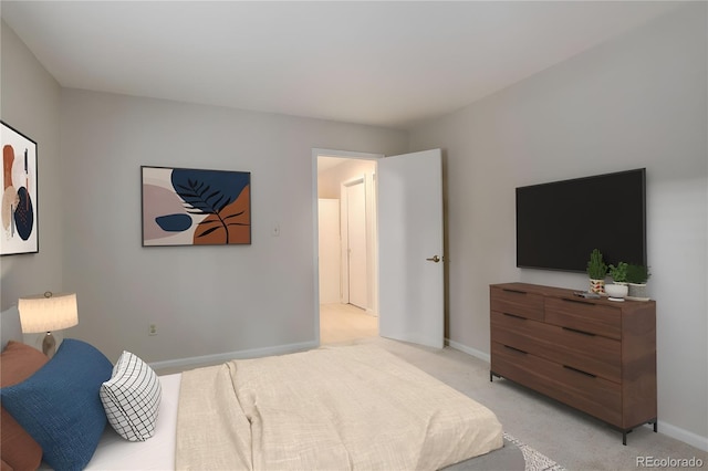 bedroom featuring light colored carpet and baseboards