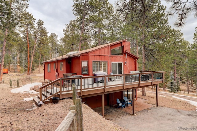 rustic home with a patio area and a deck