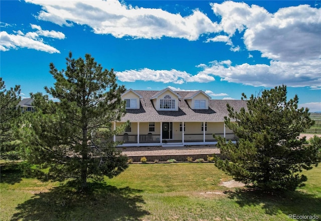 895 Antelope Dr W, Bennett, CO 80102 - view of front of house featuring covered porch, a front yard, and roof with shingles