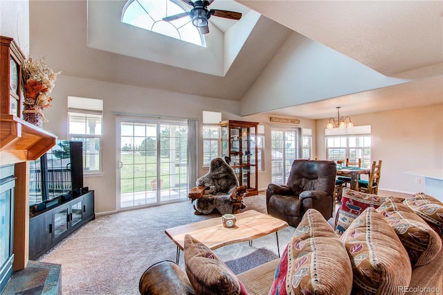 895 Antelope Dr W, Bennett, CO 80102 - living area with carpet floors, ceiling fan, a chandelier, baseboards, and high vaulted ceiling