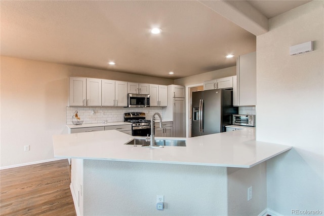 895 Antelope Dr W, Bennett, CO 80102 - kitchen featuring appliances with stainless steel finishes, a sink, baseboards, backsplash, and recessed lighting
