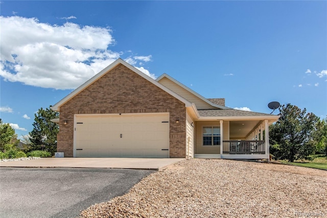 895 Antelope Dr W, Bennett, CO 80102 - single story home with brick siding, a garage, covered porch, and driveway