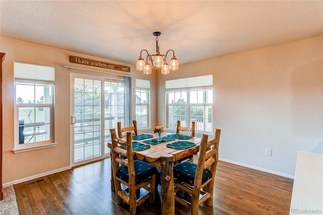 895 Antelope Dr W, Bennett, CO 80102 - dining space featuring wood finished floors, baseboards, a chandelier, and a textured wall