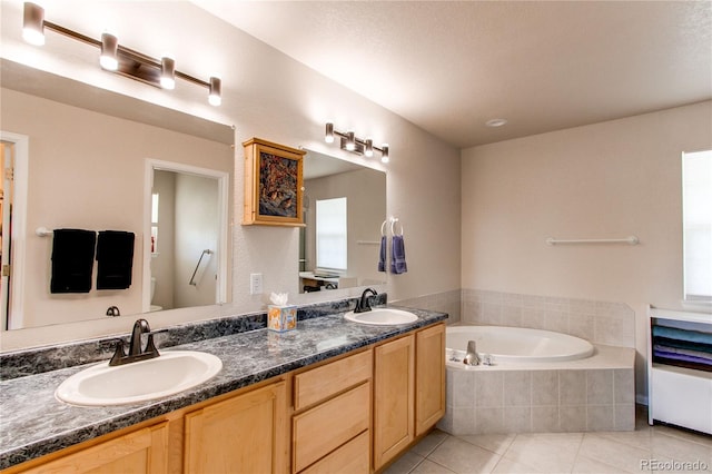 895 Antelope Dr W, Bennett, CO 80102 - bathroom featuring tile patterned floors, a bath, and double vanity