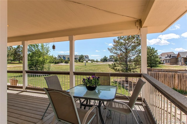 895 Antelope Dr W, Bennett, CO 80102 - wooden terrace with a lawn, outdoor dining area, and a residential view