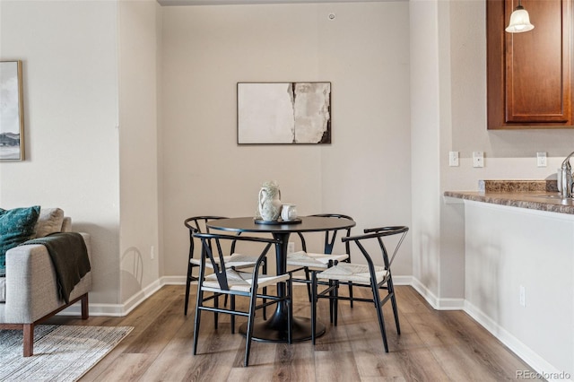 dining room featuring baseboards and wood finished floors