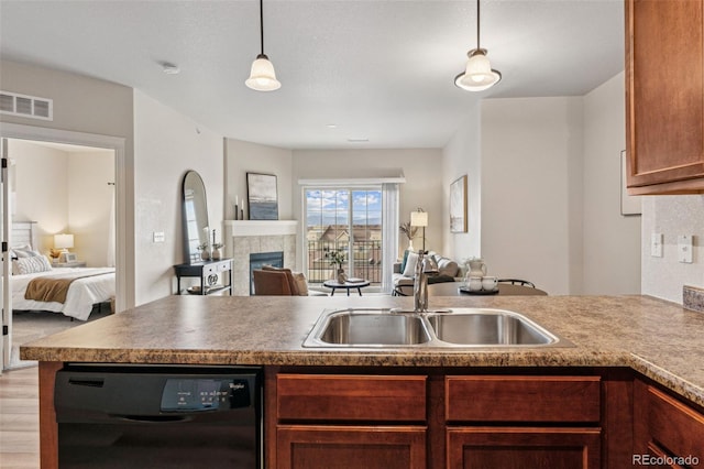 kitchen with dishwasher, open floor plan, a sink, and visible vents