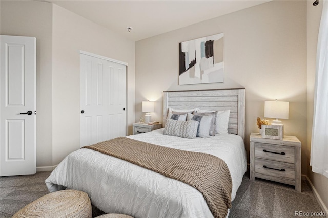 carpeted bedroom featuring a closet and baseboards