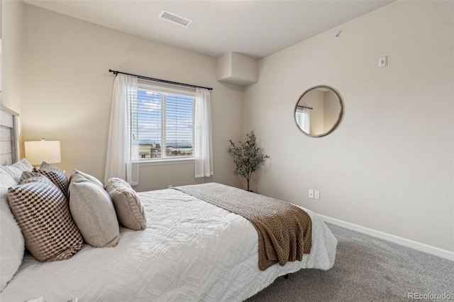 bedroom with carpet floors, visible vents, and baseboards