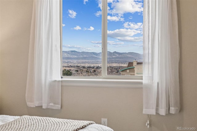 bedroom featuring a mountain view