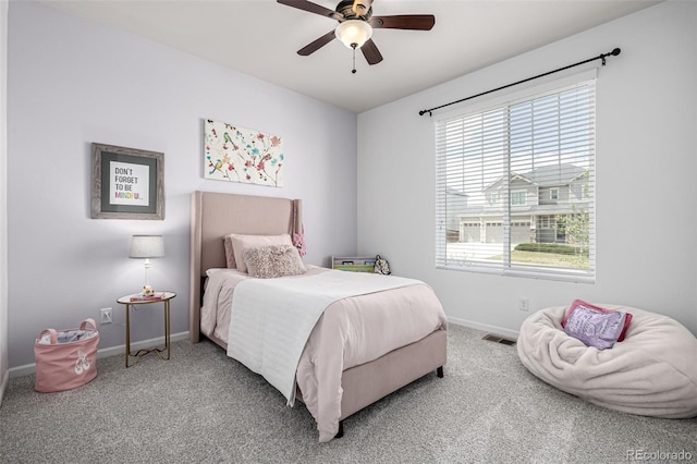 carpeted bedroom with baseboards and a ceiling fan