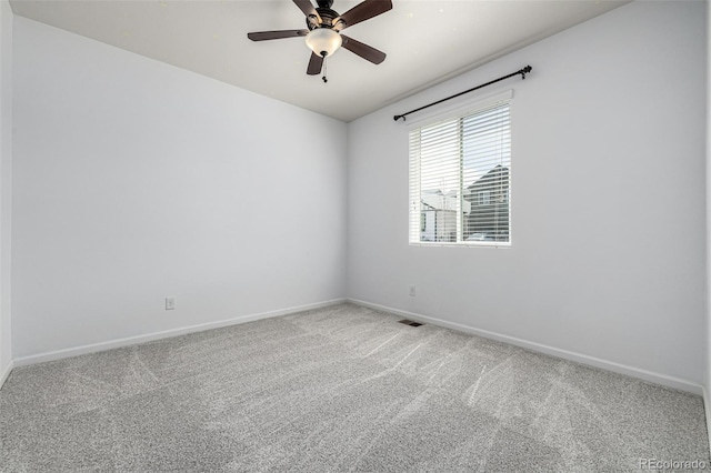 spare room with carpet, baseboards, and ceiling fan
