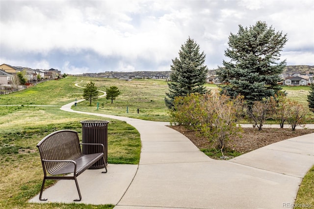 view of home's community featuring a lawn and a residential view