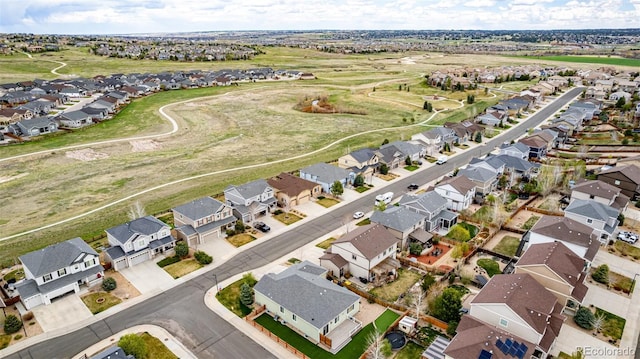 aerial view of property and surrounding area featuring nearby suburban area