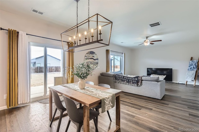 dining area with ceiling fan, visible vents, baseboards, and wood finished floors