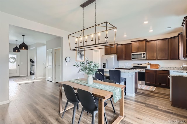 dining room featuring visible vents, recessed lighting, baseboards, and wood finished floors