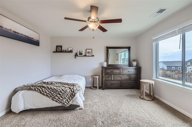 carpeted bedroom featuring visible vents, ceiling fan, and baseboards