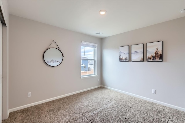 interior space with visible vents, baseboards, and carpet flooring