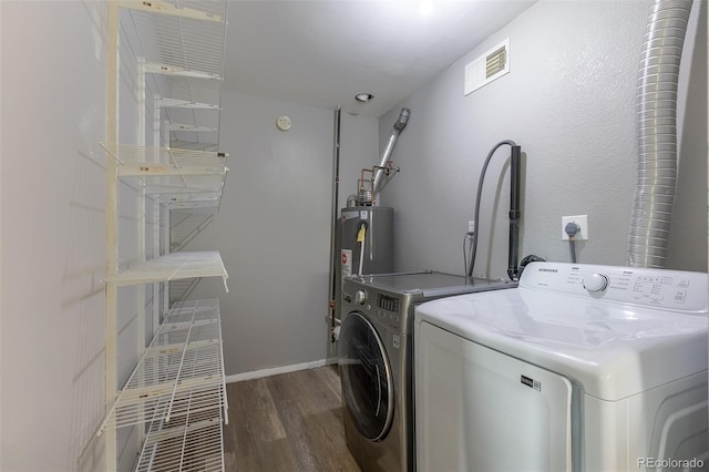 1099 Wheeling St, Aurora, CO 80011 - washroom with washing machine and dryer, wood finished floors, and electric water heater