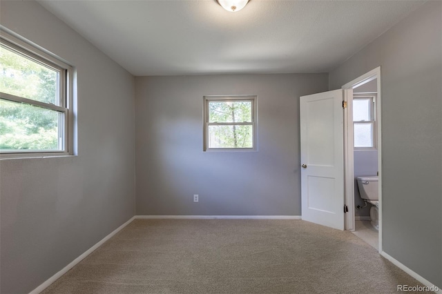 1099 Wheeling St, Aurora, CO 80011 - unfurnished bedroom with light colored carpet and baseboards
