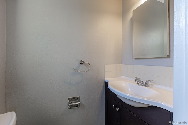 1099 Wheeling St, Aurora, CO 80011 - bathroom featuring vanity and tasteful backsplash