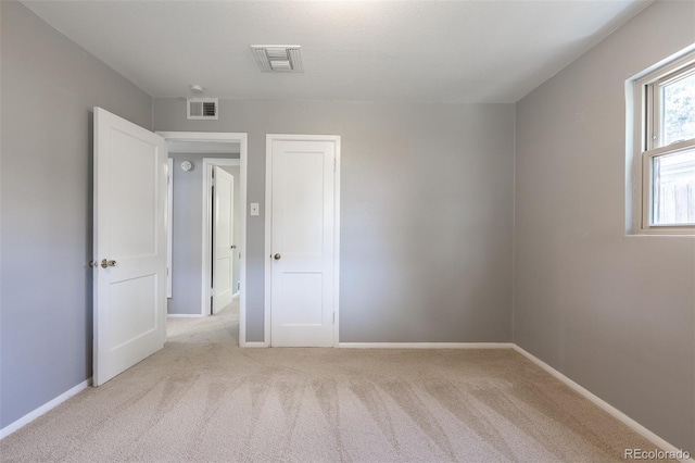 1099 Wheeling St, Aurora, CO 80011 - unfurnished bedroom featuring light carpet