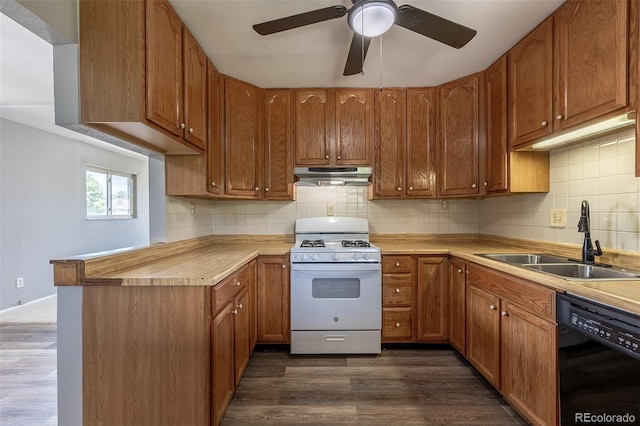 1099 Wheeling St, Aurora, CO 80011 - kitchen featuring dishwasher, gas range gas stove, under cabinet range hood, dark wood-style floors, and a peninsula