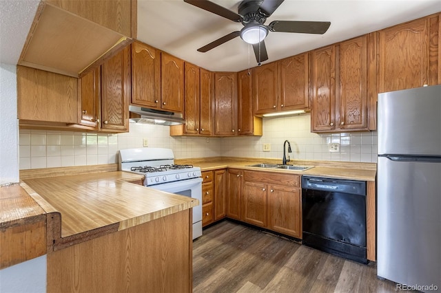 1099 Wheeling St, Aurora, CO 80011 - kitchen with black dishwasher, freestanding refrigerator, gas range gas stove, under cabinet range hood, and dark wood-type flooring