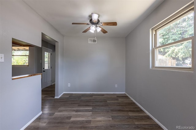 1099 Wheeling St, Aurora, CO 80011 - unfurnished room with healthy amount of natural light, dark wood-type flooring, and ceiling fan