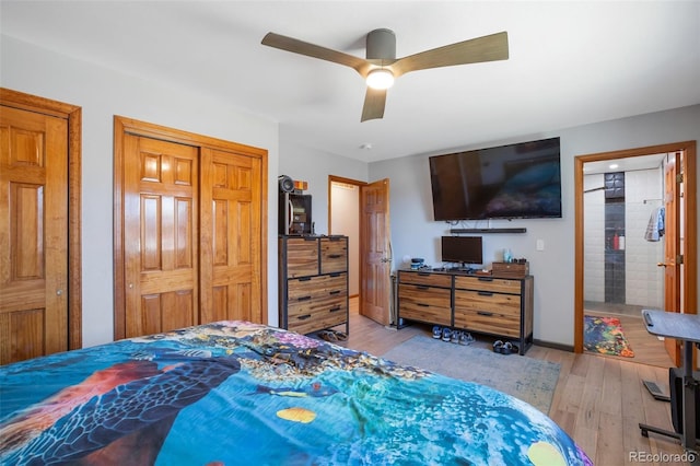 bedroom featuring wood finished floors, a ceiling fan, and baseboards