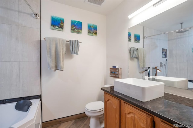 full bathroom with visible vents, toilet, a washtub, a tile shower, and vanity