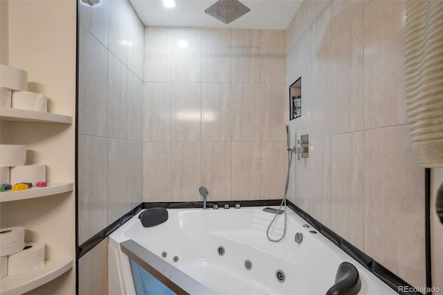 full bathroom featuring a whirlpool tub, a tile shower, and tile walls