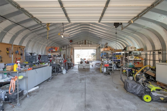 garage with a workshop area and metal wall