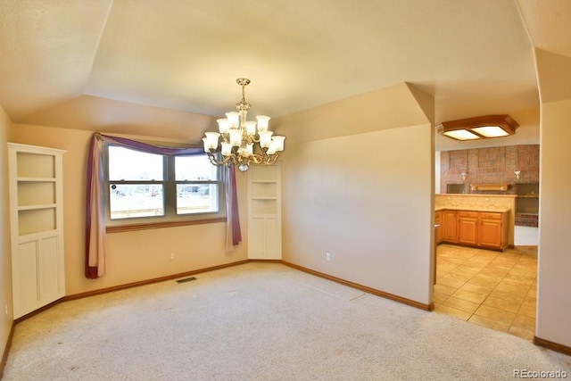 empty room featuring light carpet and an inviting chandelier