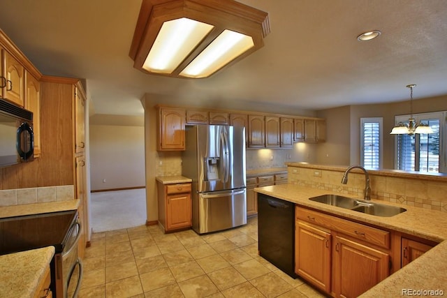 kitchen featuring pendant lighting, sink, decorative backsplash, and black appliances