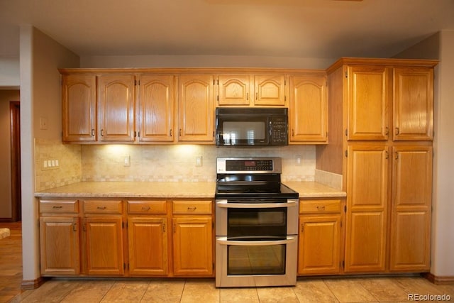 kitchen with double oven range and decorative backsplash